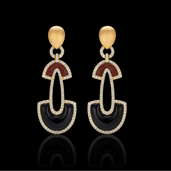 Matturi pair of gold, black, and red earrings on a black background