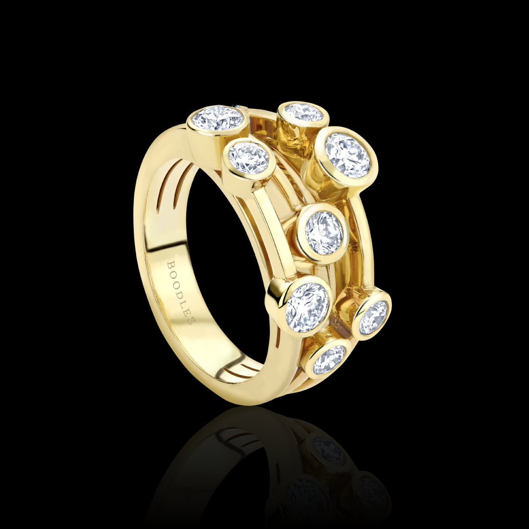 Boodles gold ring with diamonds on a black background